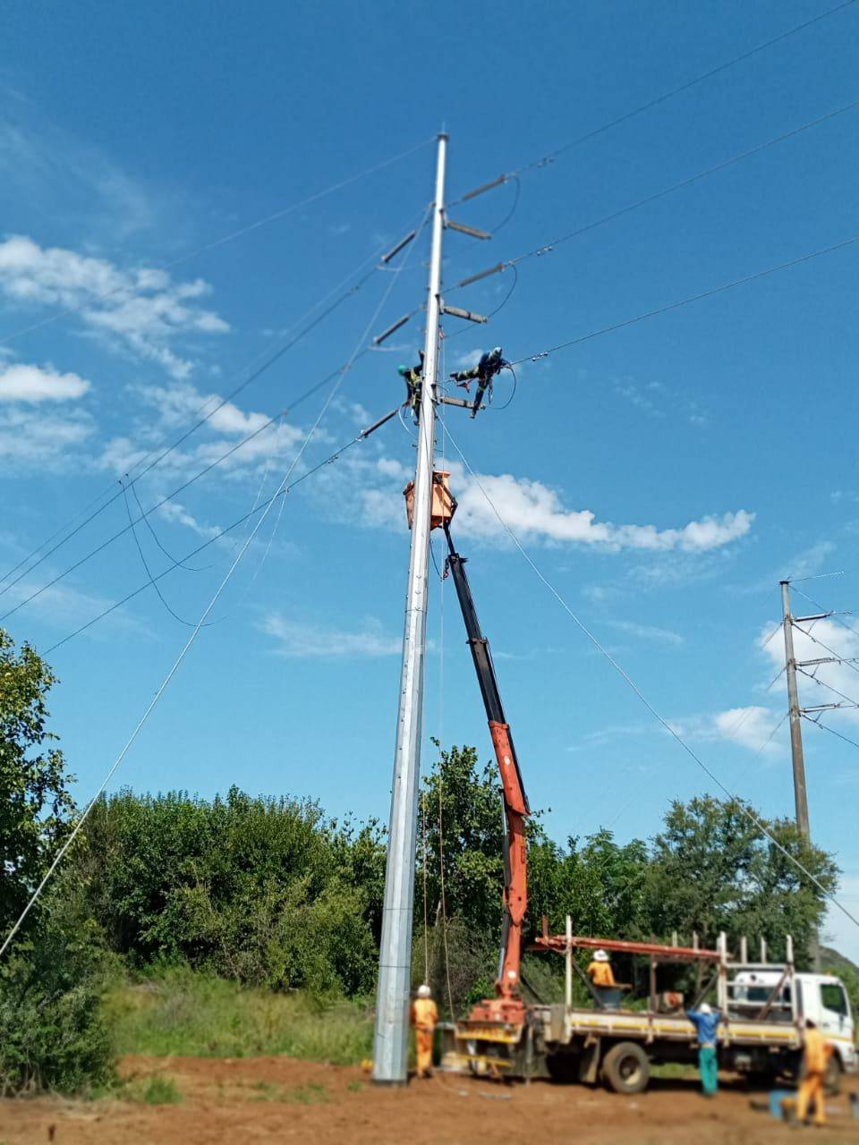 Bucket truck crew on a distribution pole
