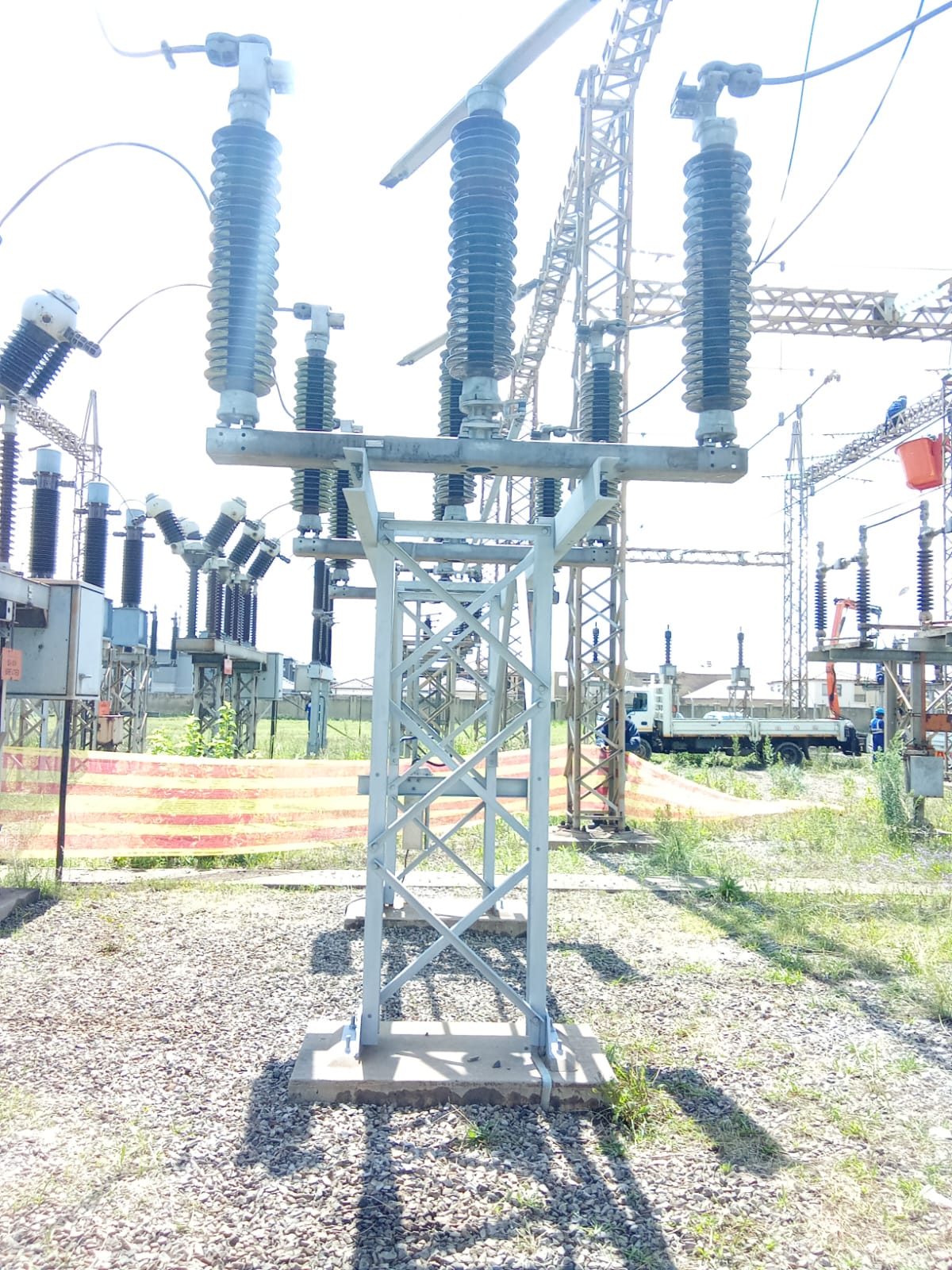 High-voltage isolator assembly and site crew at Tosa Substation