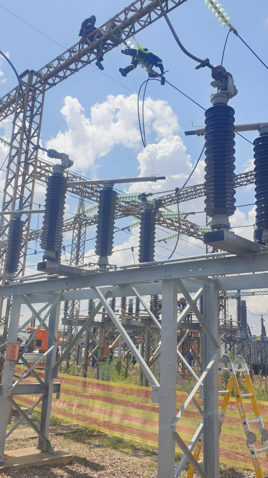 Technicians on a steel gantry at Tosa Substation