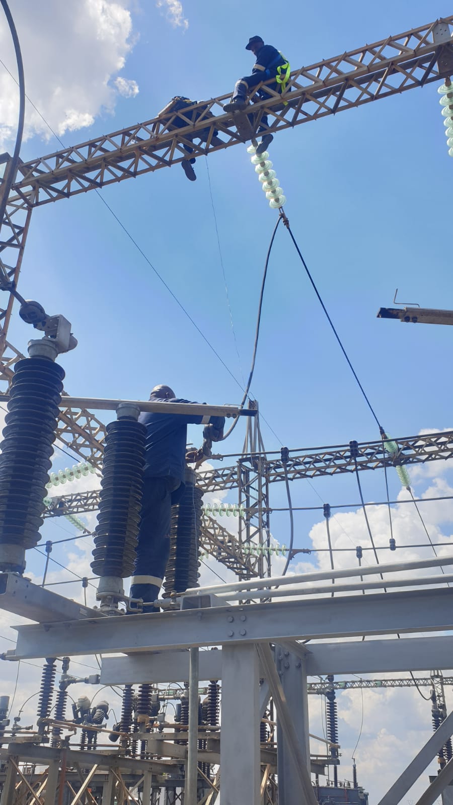 Crew coordinating HV equipment installation